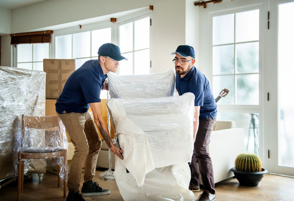 london movers carrying armchair during furniture moving service